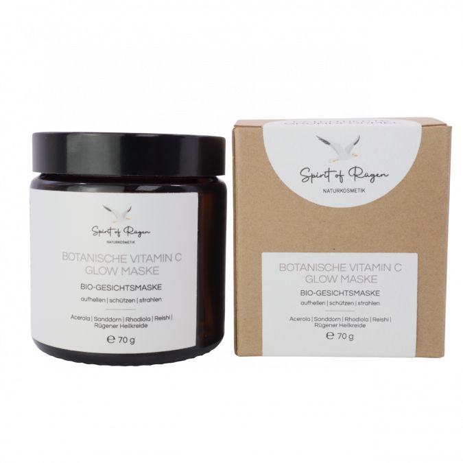 Braunes Glas mit schwarzem Deckel und Karton. Text: Botanische Vitamin C Glow Maske, Bio-Gesichtsmaske, 70 g.