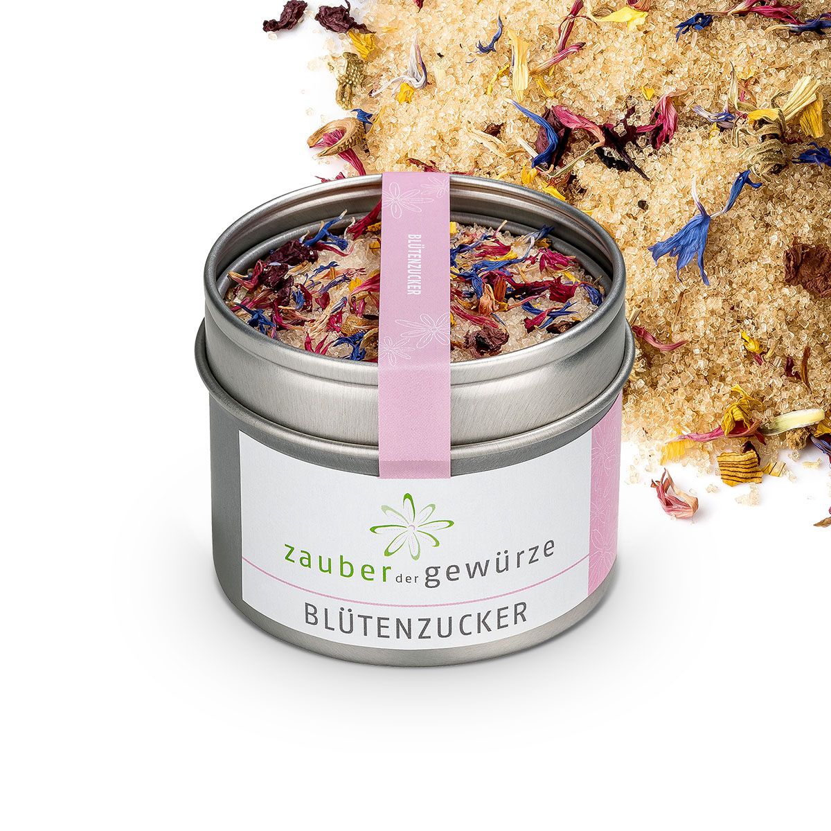 Geöffnete Dose Blütenzucker, daneben Zuckerstreusel. Rosa Etikett mit Schriftzug. Dose aus Metall.