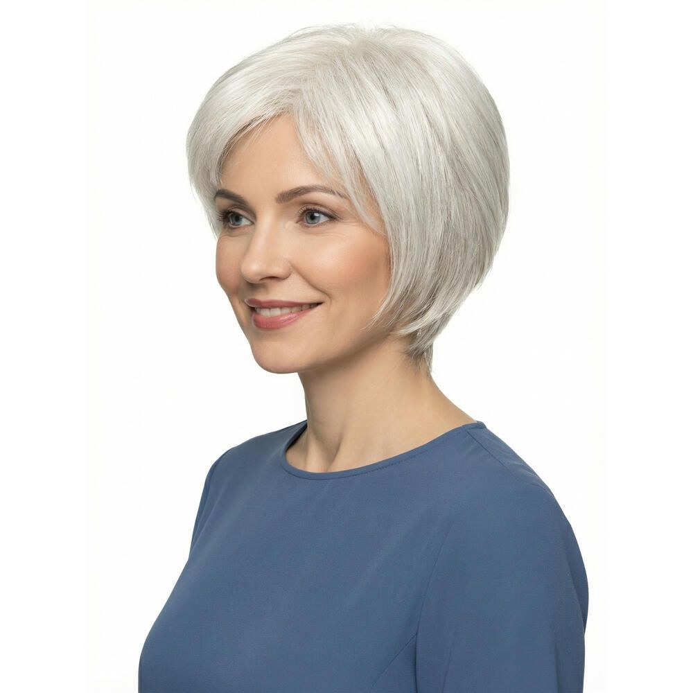 Perücke mit kurzem, grauem Haar. Die Frau trägt ein blaues Oberteil. Sie lächelt.