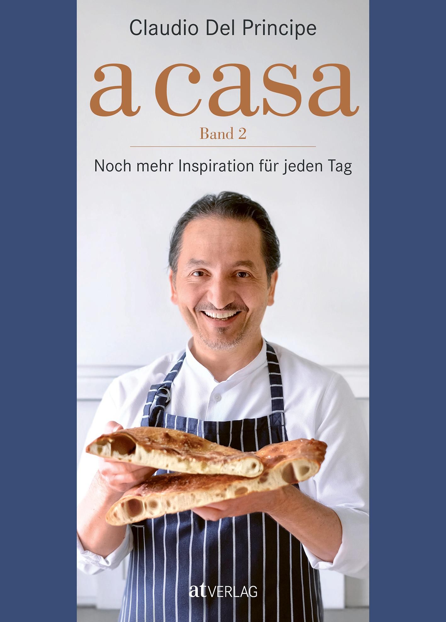 Buchcover mit dem Titel "a casa Band 2". Ein Mann hält zwei Brote. Autor: Claudio Del Principe. Verlag: atVERLAG.