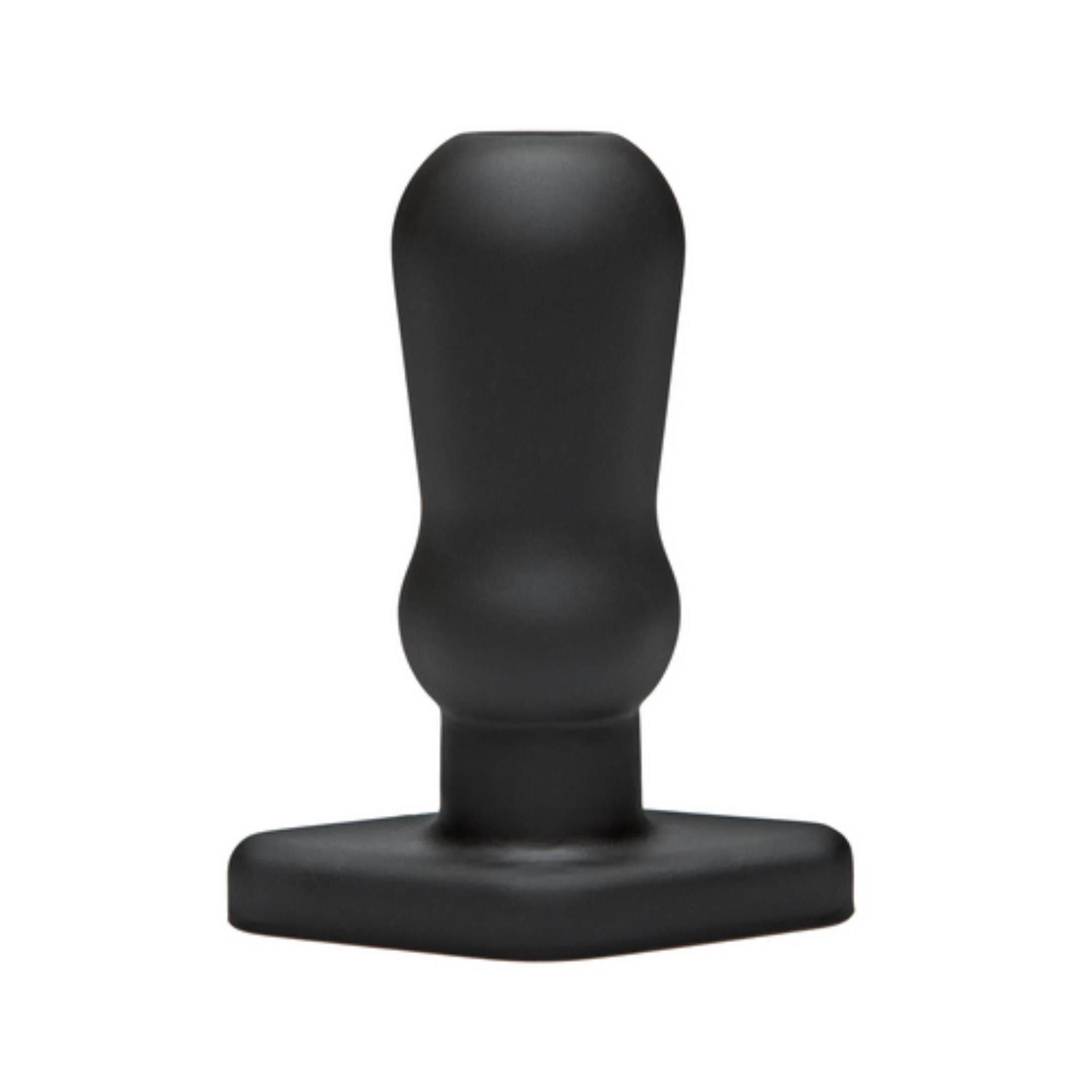 Schwarzer Anus-Plug. T-förmige Basis, zylindrischer Schaft, abgerundete Spitze. Keine sichtbaren Merkmale.