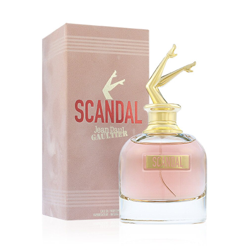 Parfümflakon mit goldfarbenen Beinen als Verschluss. Rosa Flüssigkeit, rosa Verpackung mit Schriftzug "SCANDAL".