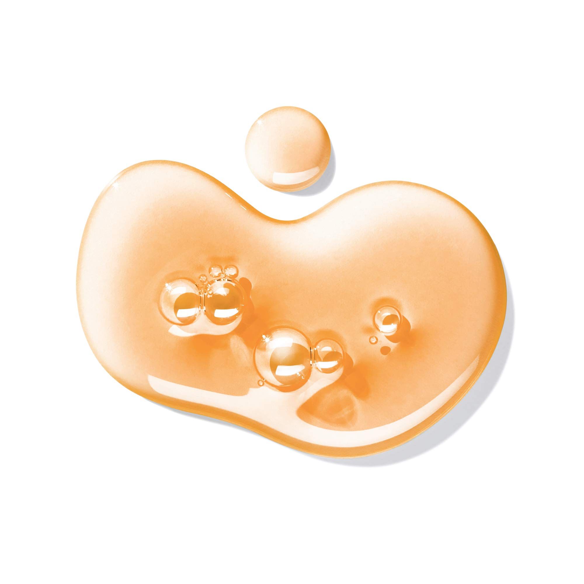 Tropfen von orangefarbenem Duschgel mit Bläschen auf weißem Hintergrund.