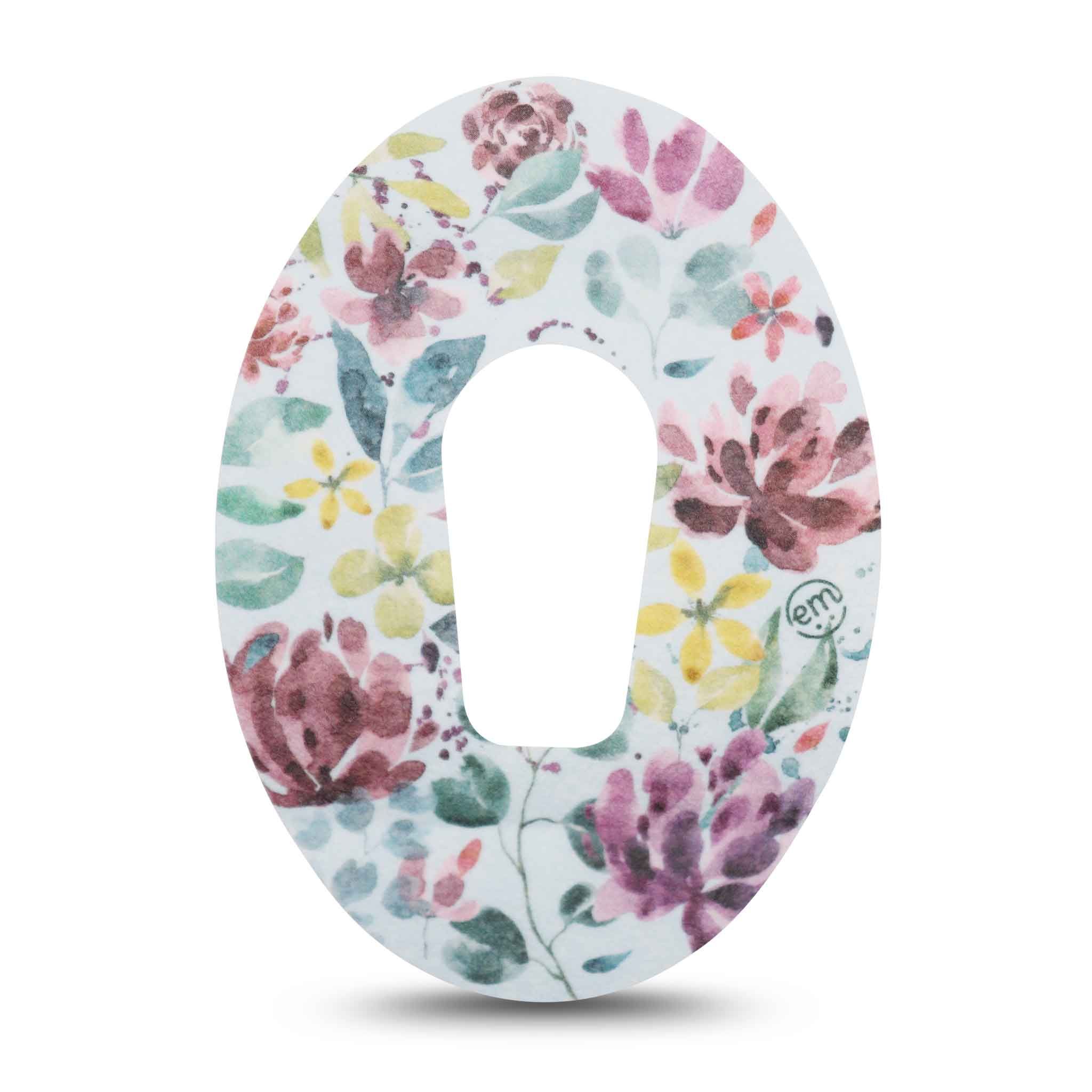 Einzelnes Pflaster mit floralem Muster. Ovale Form mit zentraler Öffnung. Sichtbare Blüten in Rosa, Gelb und Lila.
