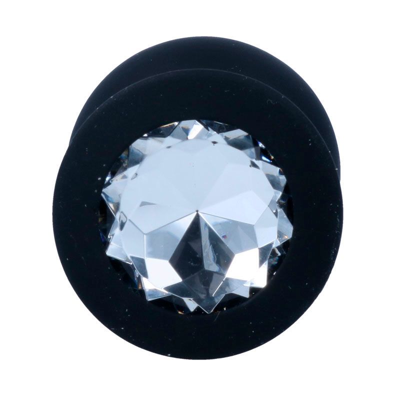 Nahaufnahme des Sockels eines schwarzen Analplugs mit Kristallverzierung.