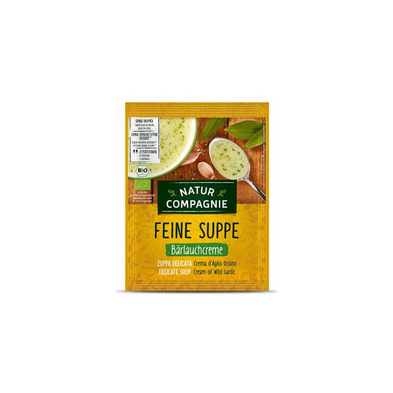 Gelbe Verpackung mit "Natur Compagnie"-Logo und "Feine Suppe Bärlauchcreme". Abbildung von Suppe, Knoblauch und Blättern.