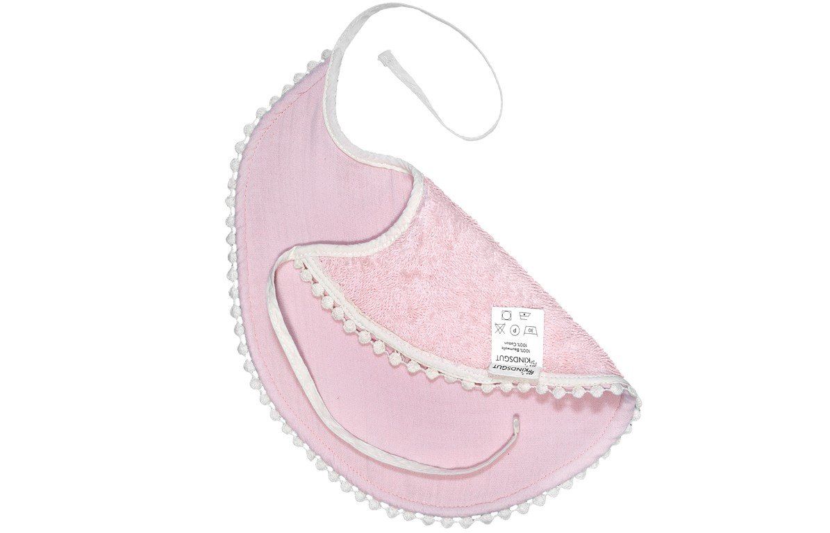 Rosa Lätzchen mit weißer Spitze und Bindebändern. Etikett mit Waschsymbolen.