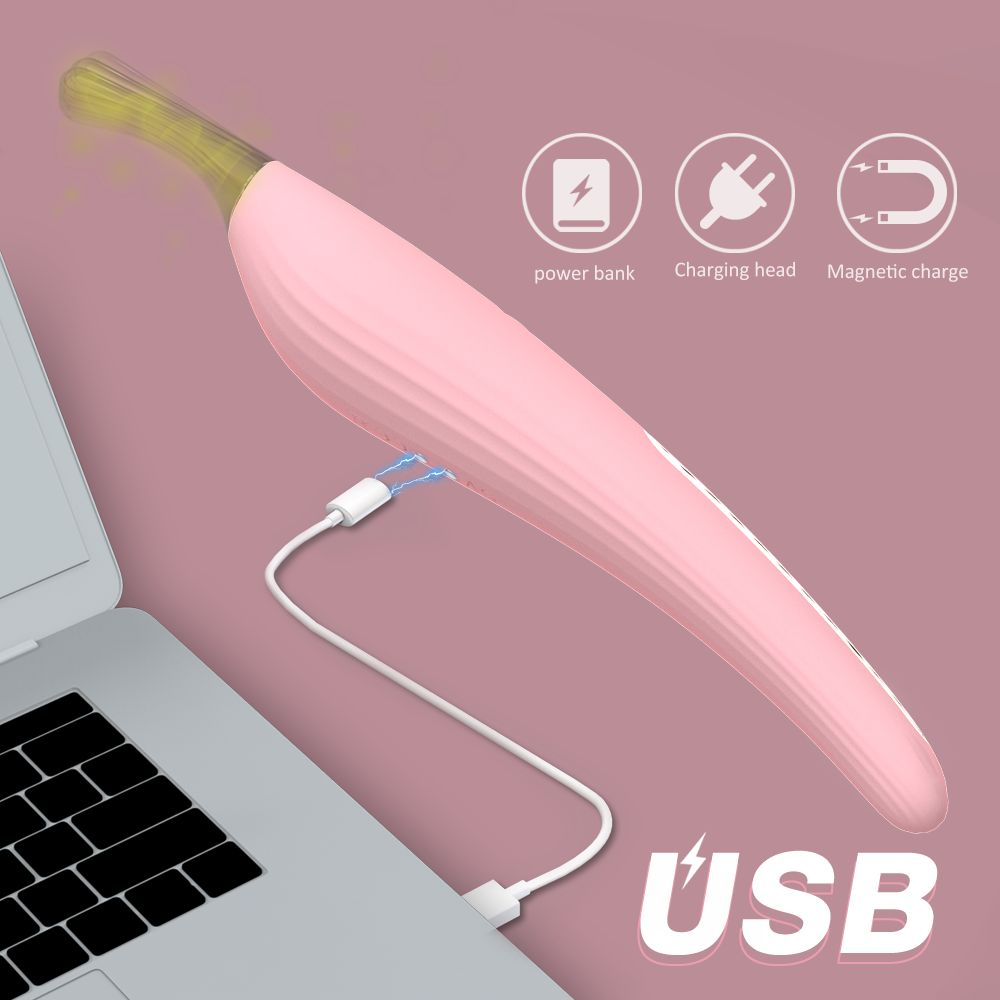 Rosa Vibrator mit goldfarbenem Kopf, verbunden mit einem USB-Kabel an einem Laptop. Ladeanschluss und Magnetladung.