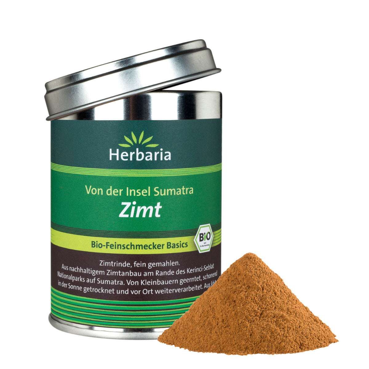 Zimt-Pulver neben Dose mit Deckel. Dose mit Herbaria-Logo, Text: Zimt, Bio. Braunes Pulver auf weißem Hintergrund.