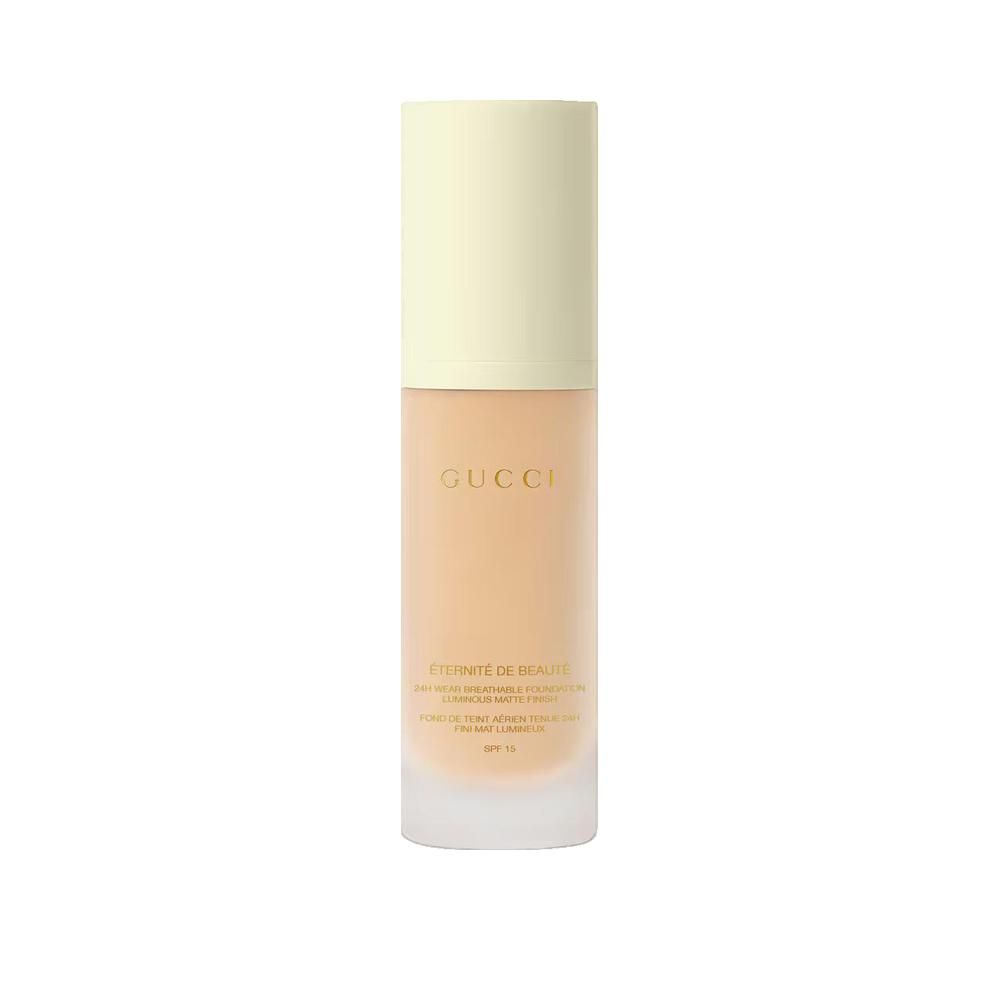 Beige Foundation-Flakon mit gelbem Deckel. Aufschrift: Gucci, Éternité de Beauté. Hohe Deckkraft, SPF 15.