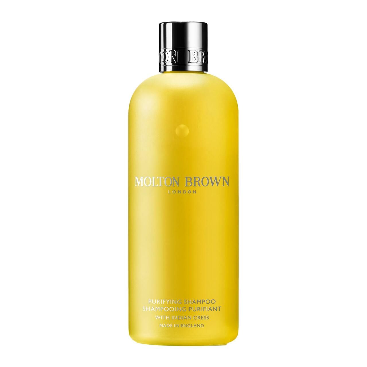 Gelbe Flasche mit silbernem Deckel. Aufschrift: Molton Brown London, Purifying Shampoo, Made in England.