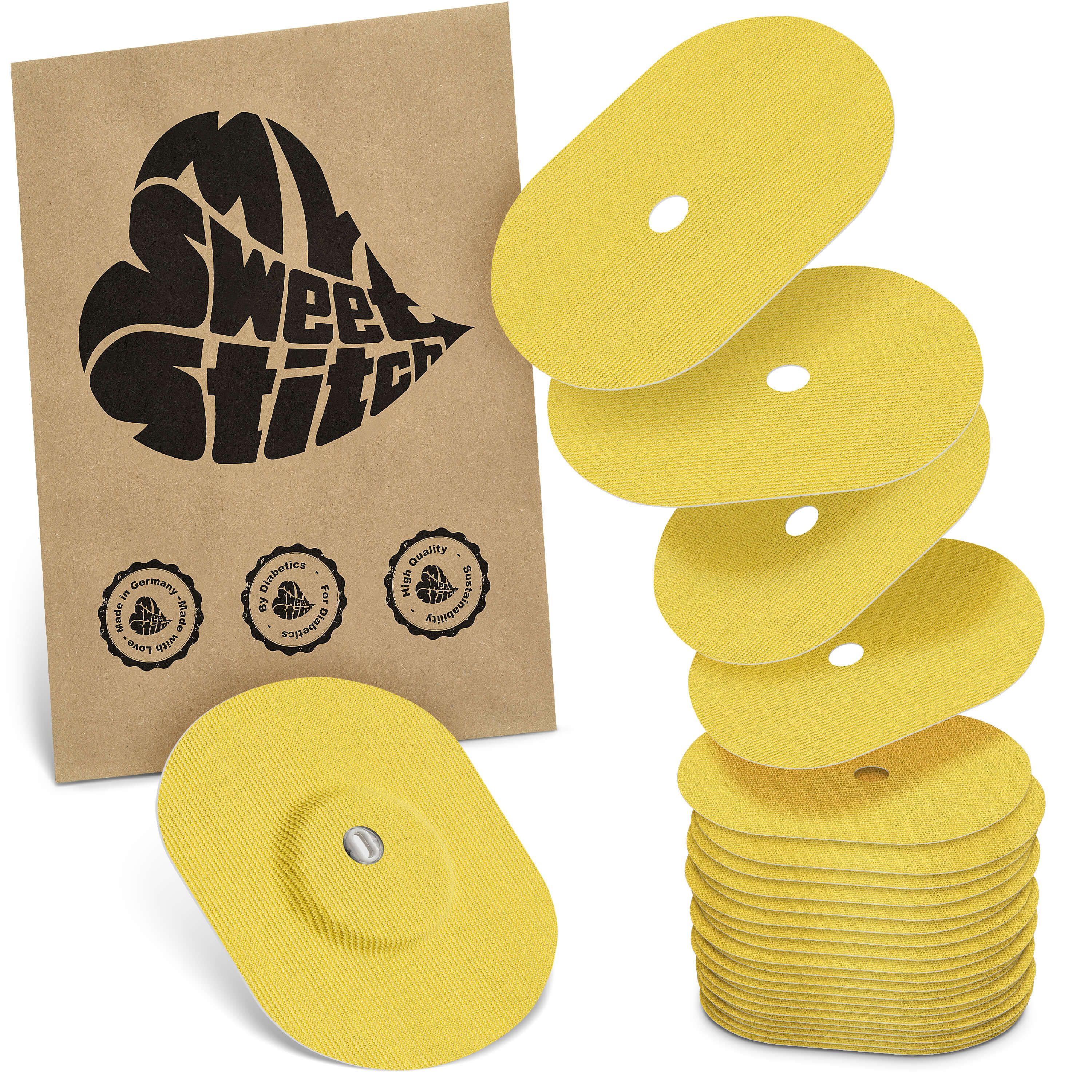 Gelbe, ovale Pflaster mit Loch, neben einer braunen Papiertüte mit Logo. Einige Pflaster sind gestapelt.