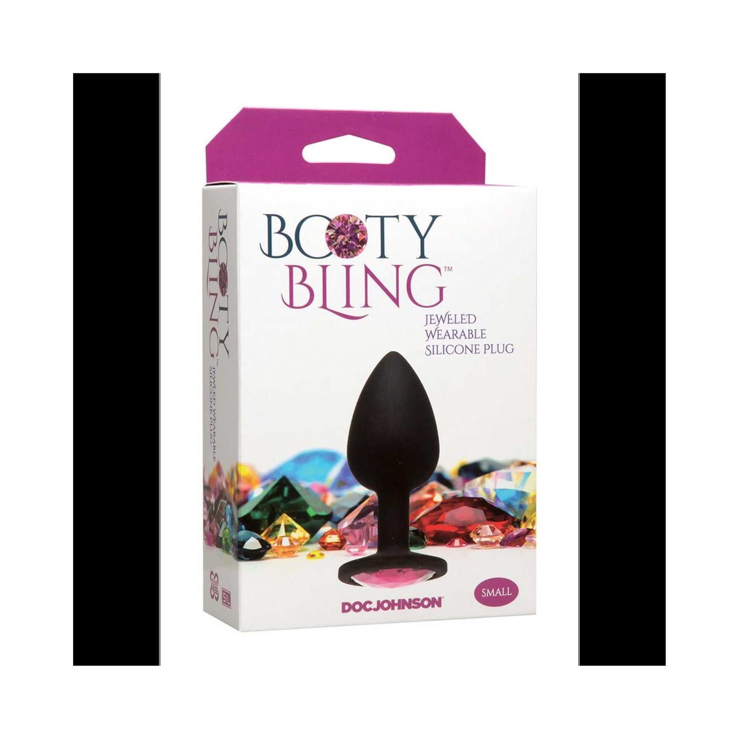 Verpackung von Booty Bling. Schwarzer, spatenförmiger Plug mit rosa Basis. Aufschrift: "Jeweled Wearable Silicone Plug". Marke: Doc Johnson. Größe: Small.