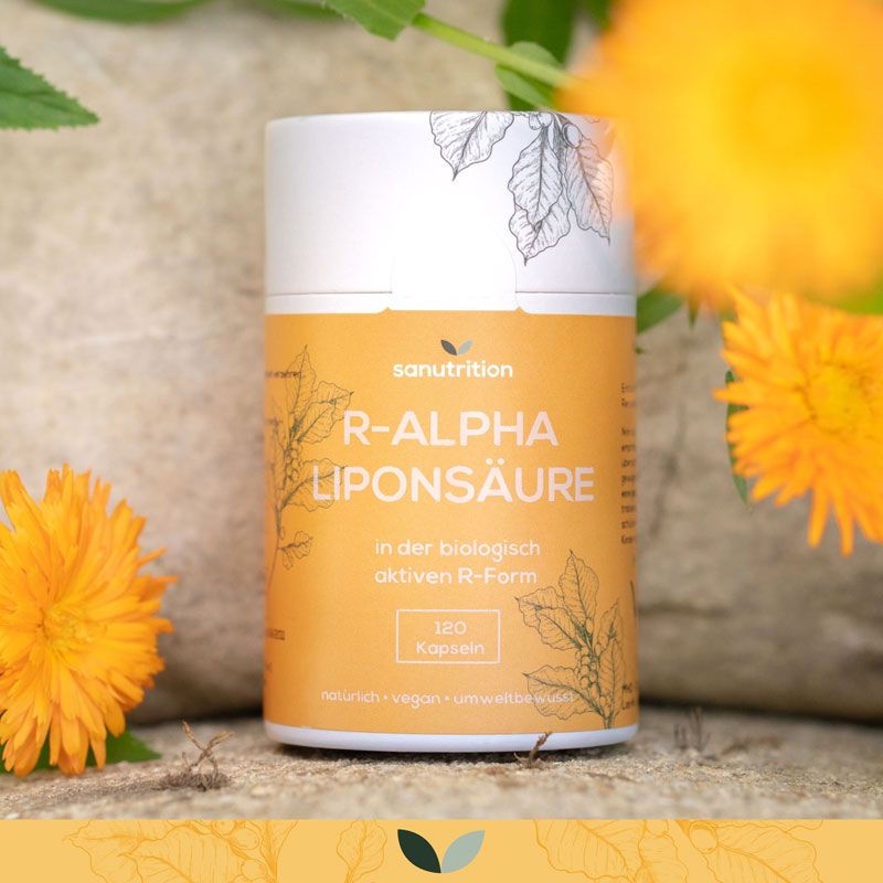 Sanutrition R-Alpha Liponsäure Dose, umgeben von gelben Blüten. Orangefarbenes Etikett mit Text und Blättermuster. 120 Kapseln.