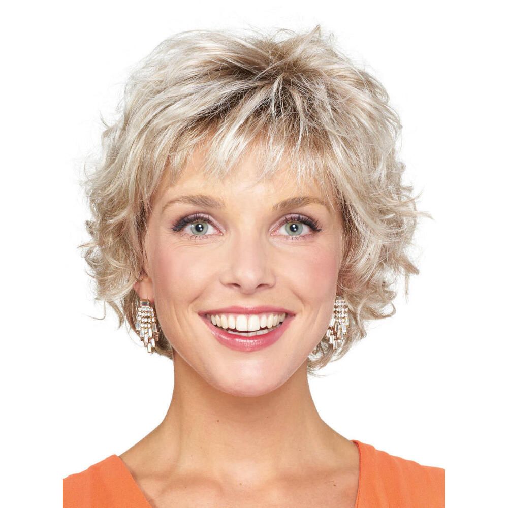 Kurzhaarperücke mit lockigem, blondem Haar. Frau mit orangefarbenem Oberteil. Blick in die Kamera.