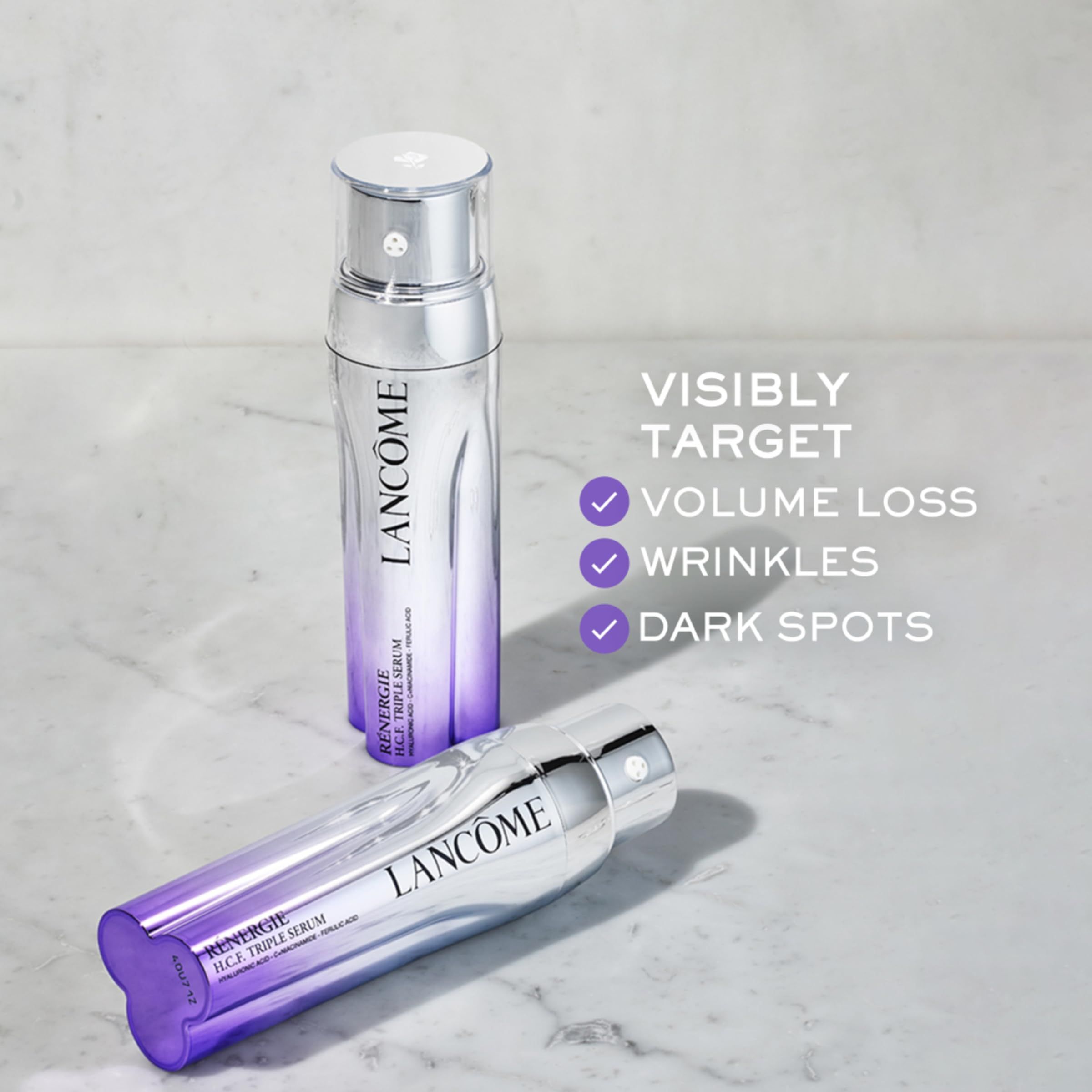Zwei Serumflaschen. Aufschrift: Lancôme, Rénergie H.C.F. Triple Serum. Text: Visibly target Volume Loss, Wrinkles, Dark Spots.