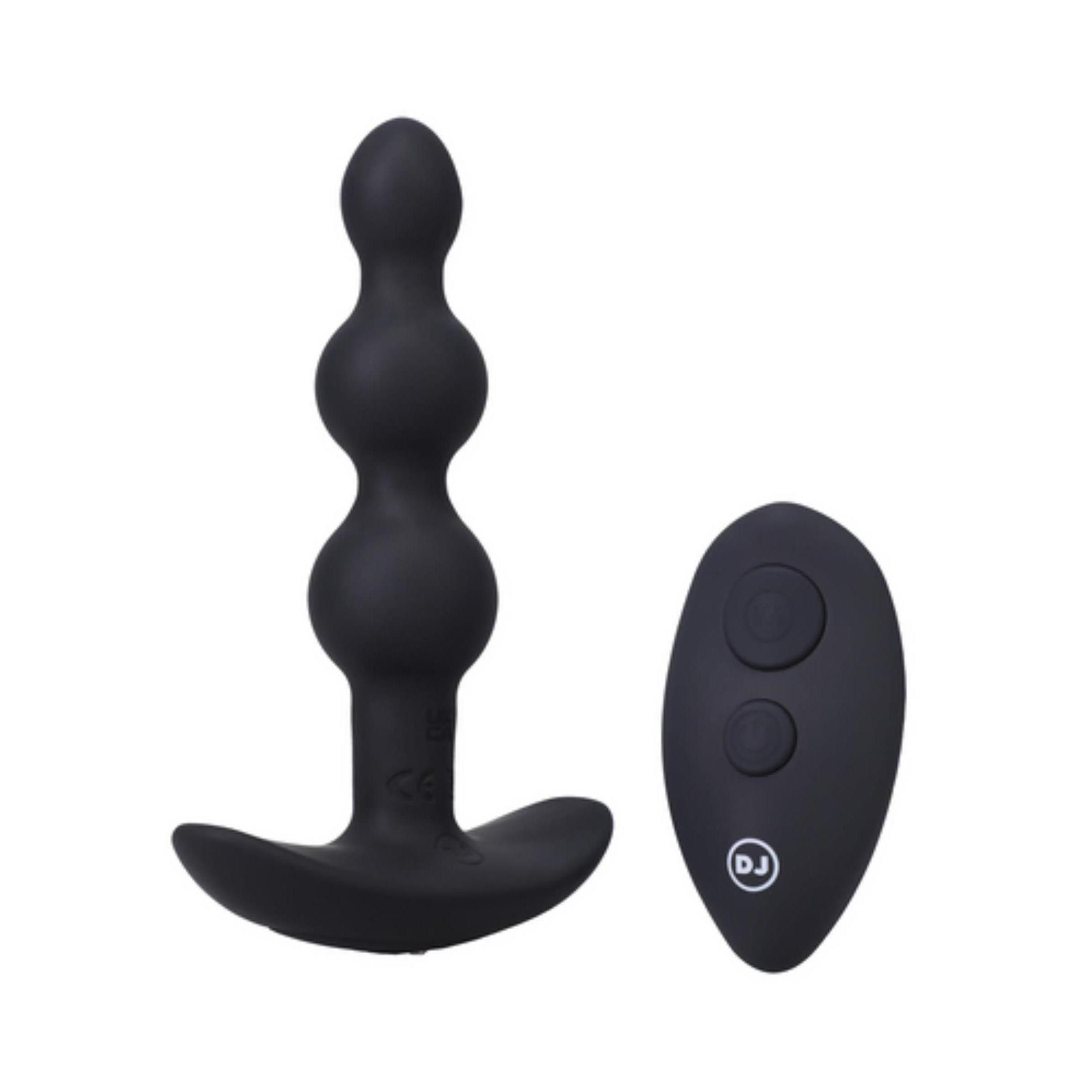 Schwarzes Analplug und Fernbedienung. Analplug mit drei Kugeln und T-förmigem Sockel. Fernbedienung mit zwei Knöpfen.