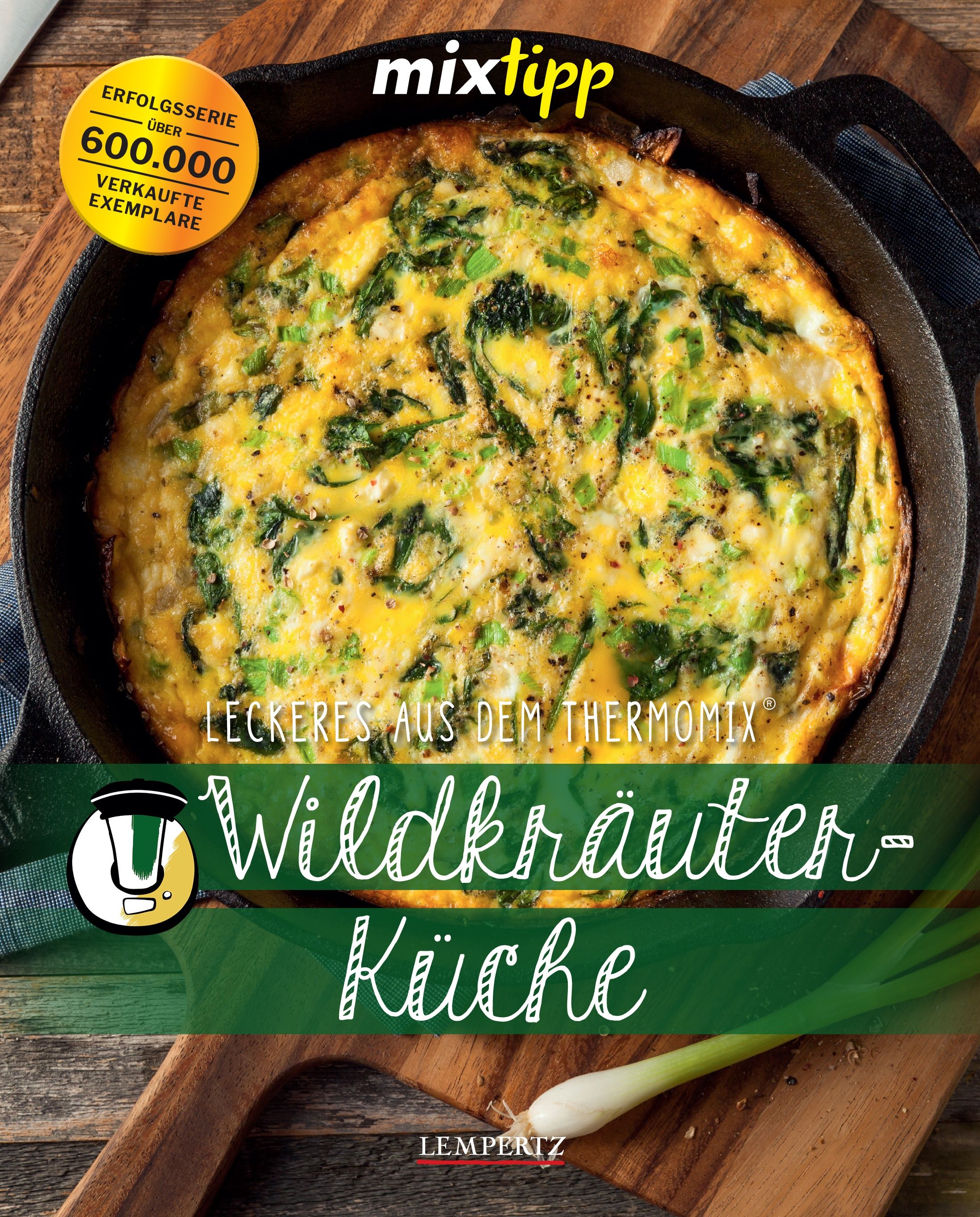 Buch "Wildkräuter-Küche" mit Omelett in Pfanne. Titel, Logo "mixtipp" und Auszeichnung "600.000 verkaufte Exemplare" sichtbar.
