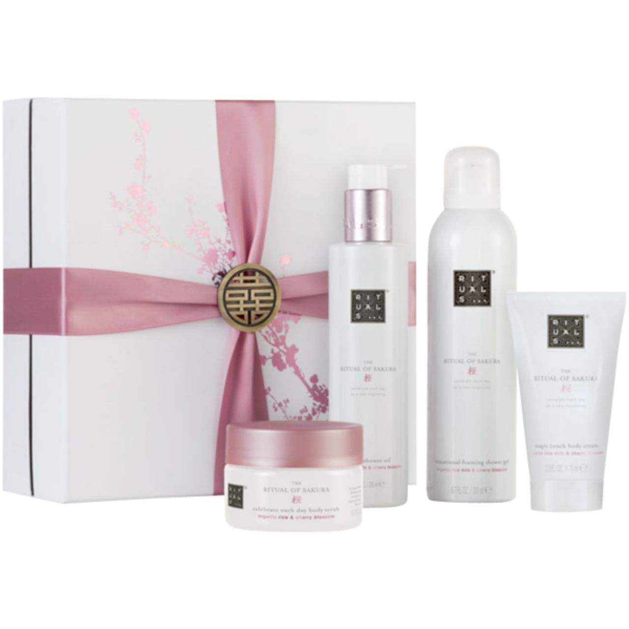 Geschenkset mit weißer Schachtel, rosa Schleife und vier Pflegeprodukten. Produkte mit weißer Verpackung und rosa Akzenten.