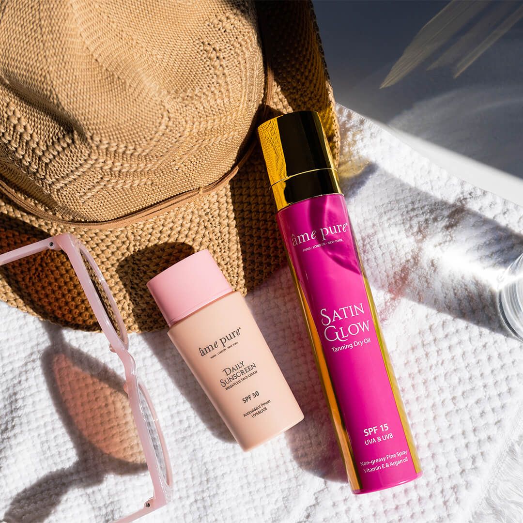 Sonnenschutz-Set mit Hut und Sonnenbrille: Tages-Sonnenschutz SPF 50 und Satin Glow Bräunungsöl.