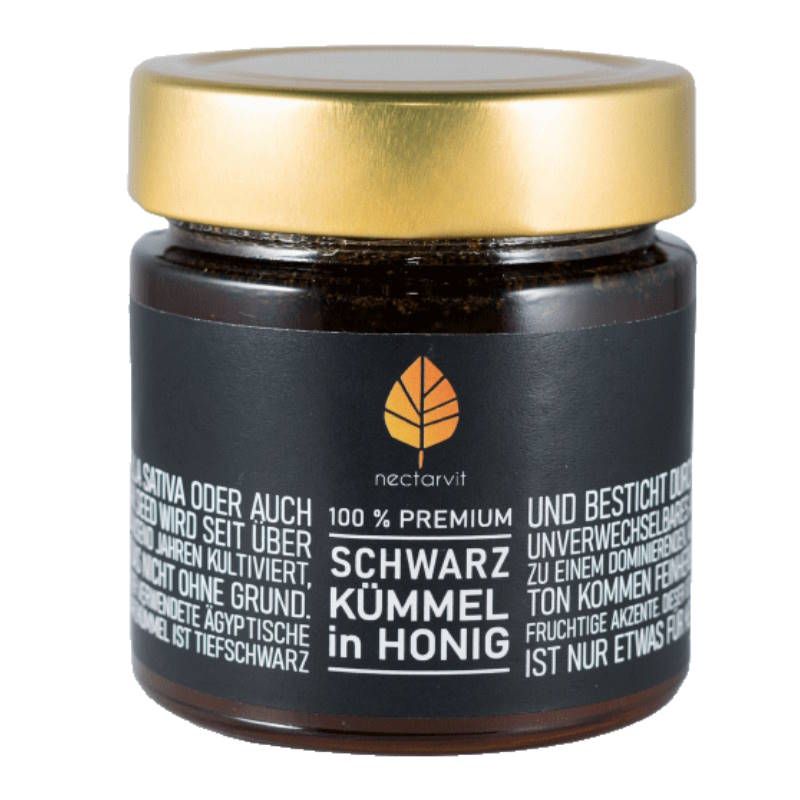 Glas mit schwarzem Honig. Goldener Deckel. Schwarzes Etikett mit Text: Schwarzkümmel in Honig. Logo: Blatt.
