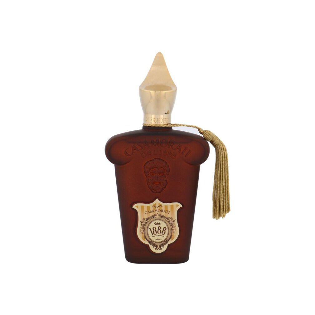 Braune Flasche mit goldener Kappe und Quaste, mit Logo und Schrift.