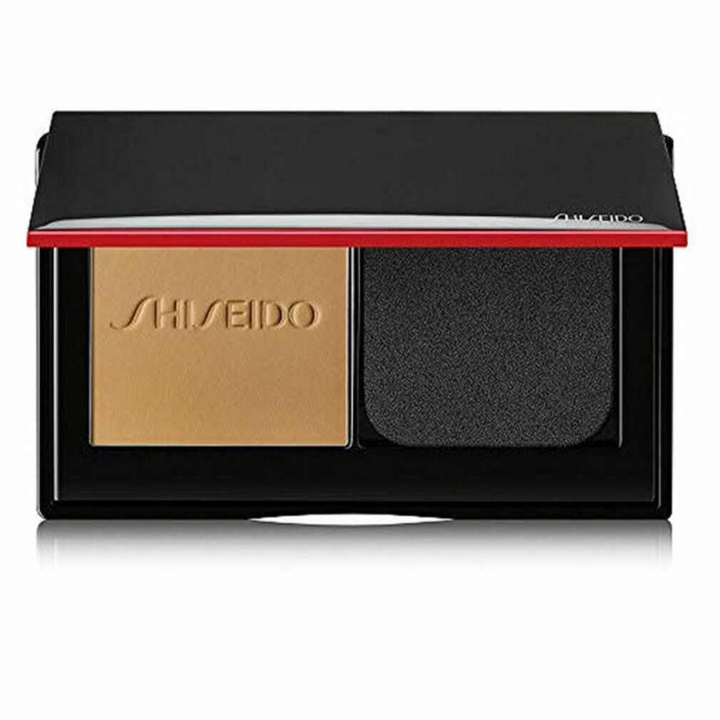 Kompaktpuder mit Puder und Schwamm. Schwarzer Rahmen, roter Akzent. Shiseido-Logo.