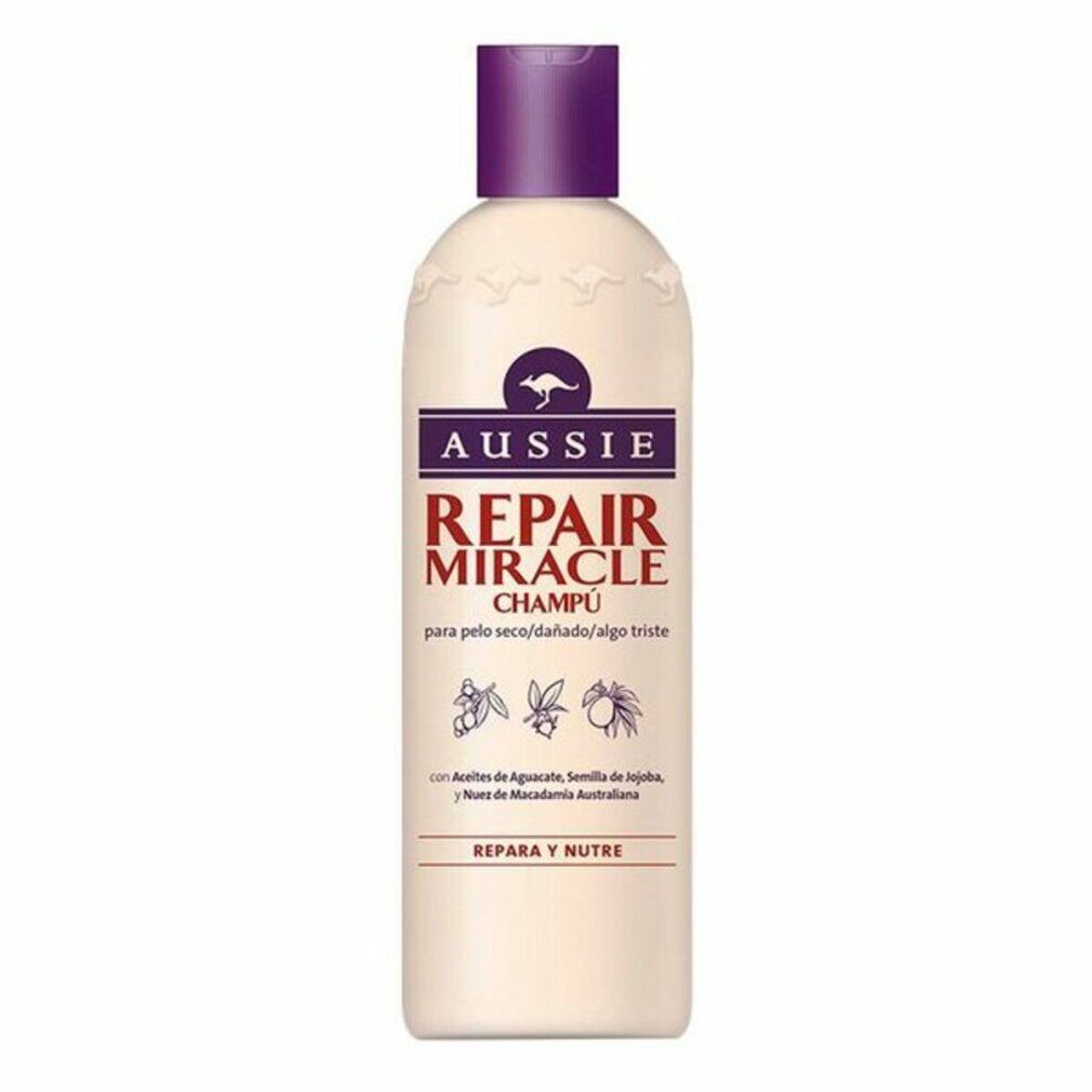 Beige Shampoo-Flasche mit lila Deckel. Aufschrift: Aussie Repair Miracle Champú. Enthält Avocado, Jojoba und Macadamia.