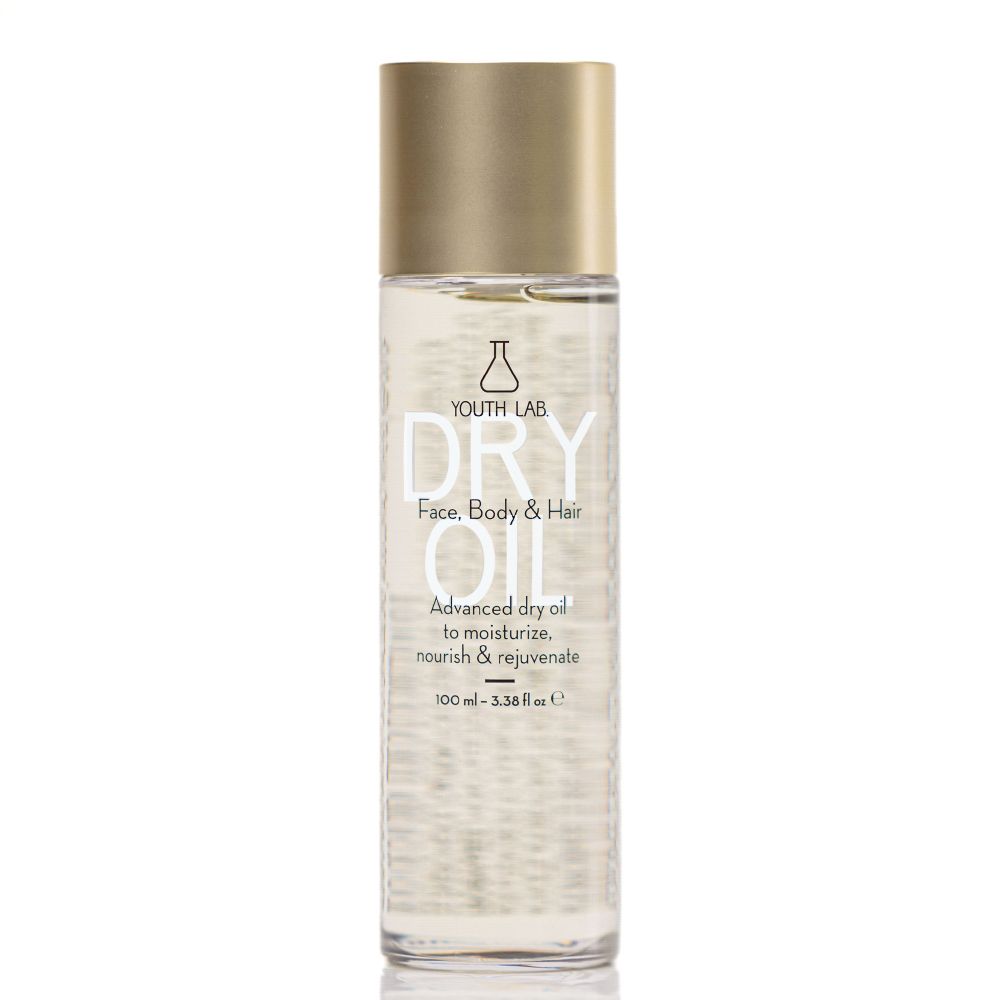 Zylindrische Flasche mit goldfarbenem Deckel. Aufschrift: YOUTH LAB DRY OIL. Für Gesicht, Körper und Haar. Enthält 100 ml.