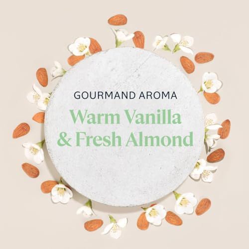 Runder Stein mit Text und Blüten und Mandeln. Text: Gourmand Aroma, Warm Vanilla & Fresh Almond.