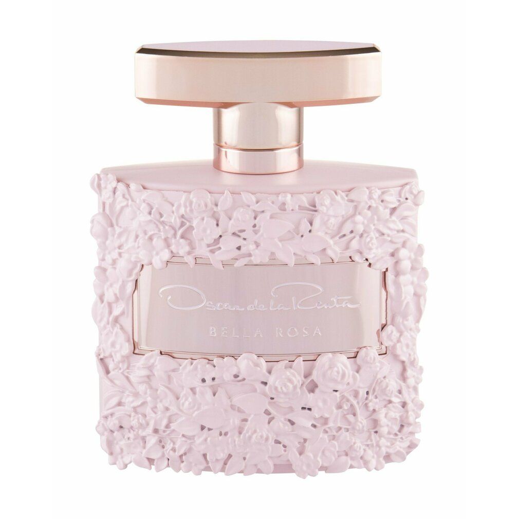 Rosa Parfümflakon mit floralem Relief. Goldfarbene Kappe. Aufschrift: Oscar de la Renta Bella Rosa.