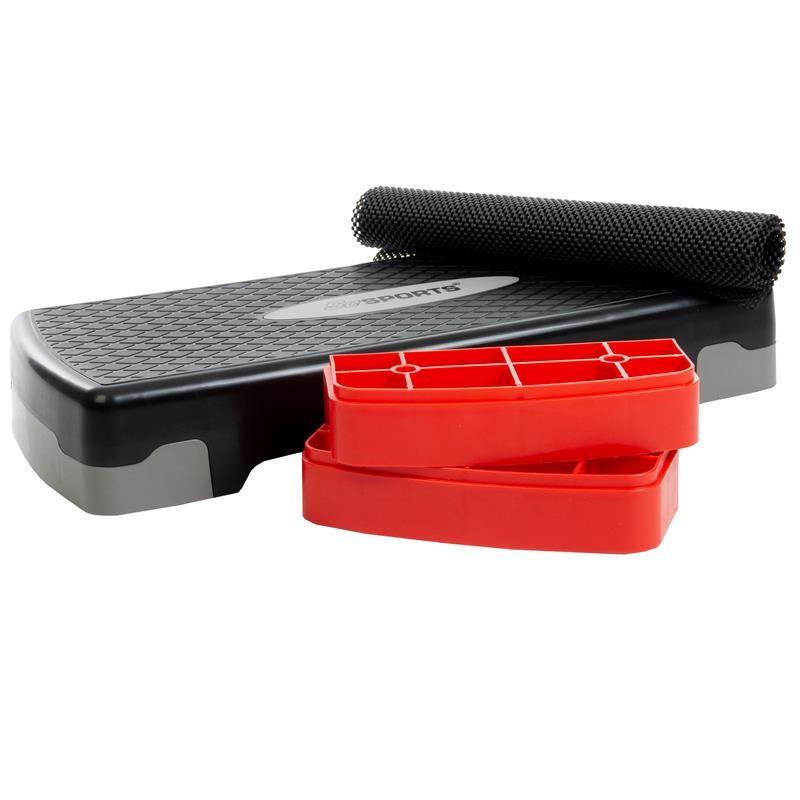 Stepper, schwarz, mit rotem und grauem Akzent. Zwei rote Erhöhungen und eine Matte sind sichtbar.