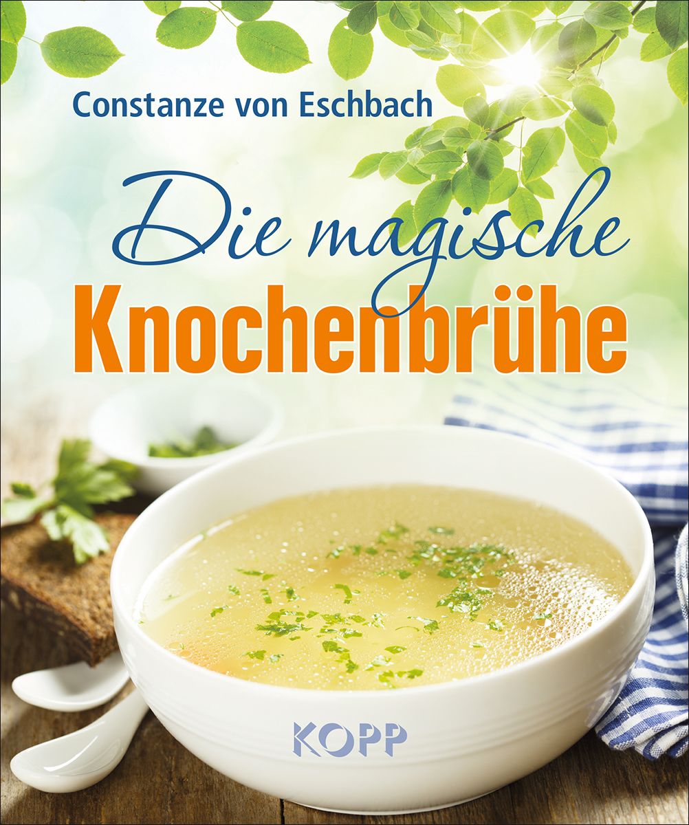 Buchcover mit Titel "Die magische Knochenbrühe". Eine Schüssel Brühe, Brot und Löffel. Autor: Constanze von Eschbach. Verlag: KOPP.