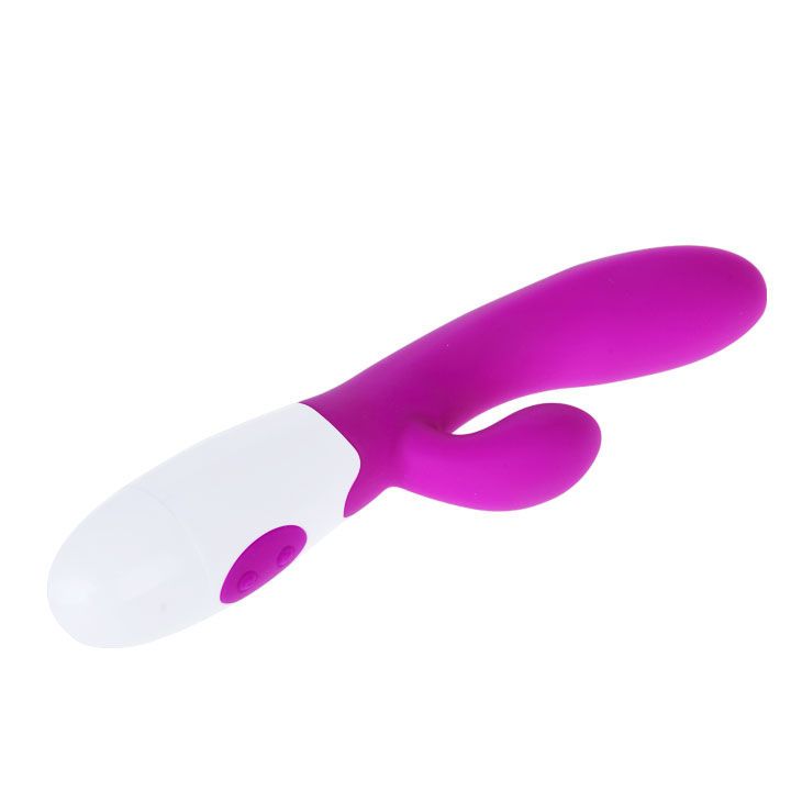 Lila Vibrator mit weißem Kopf. Zwei Knöpfe. Ergonomische Form. Aus Silikon.