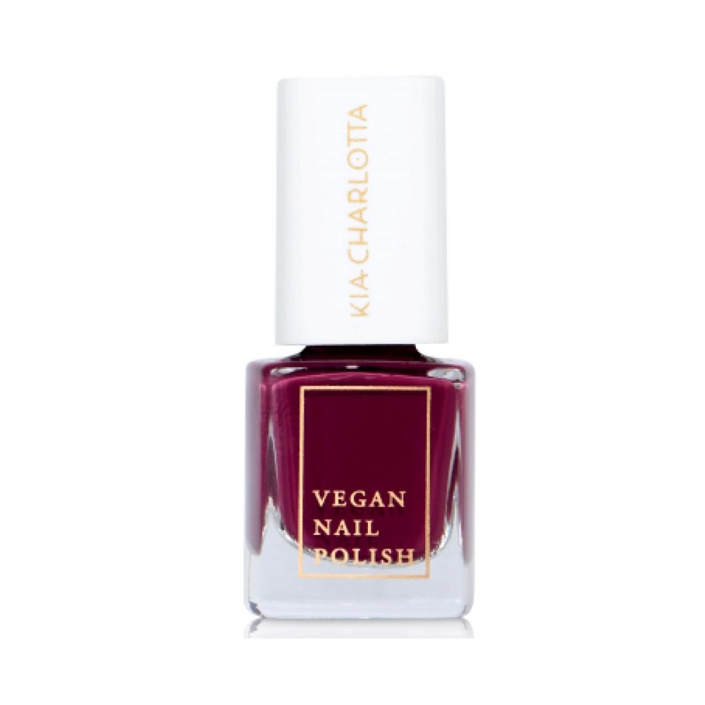 Nagellackflasche mit weißem Deckel. Auf dem Flaschenetikett steht "VEGAN NAIL POLISH". Der Lack ist dunkelrot.