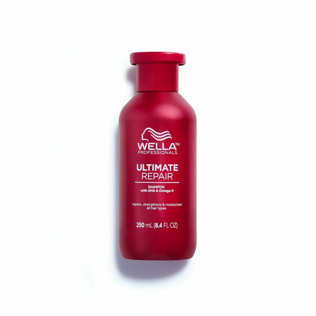 Rote Shampoo-Flasche mit weißem Logo und Schriftzug 'Ultimate Repair'. Text: 'Shampoo mit AHA & Omega-9'. Auf weißem Hintergrund.