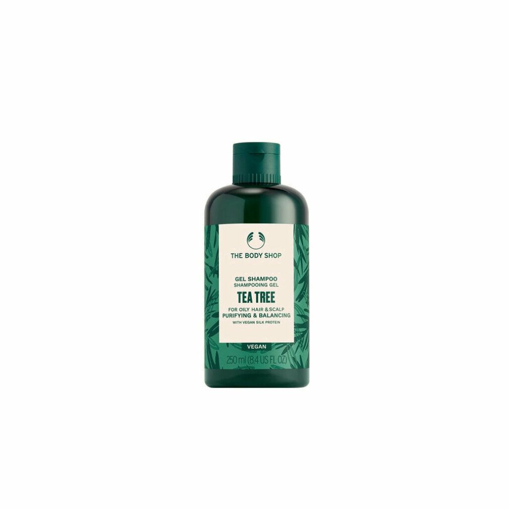 Grüne Flasche mit Shampoo. Aufschrift: Tea Tree, Gel Shampoo. Vegan. Marke: The Body Shop.