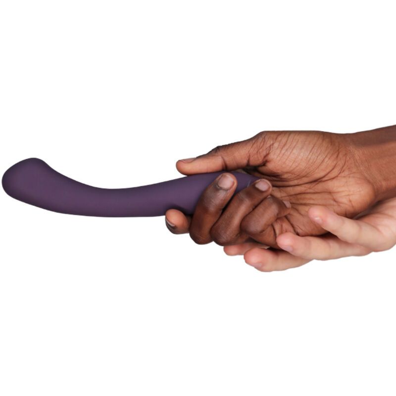 Lila Vibrator in Händen gehalten. Gebogene Form, glatte Oberfläche. Helle und dunkle Haut berühren das Produkt.