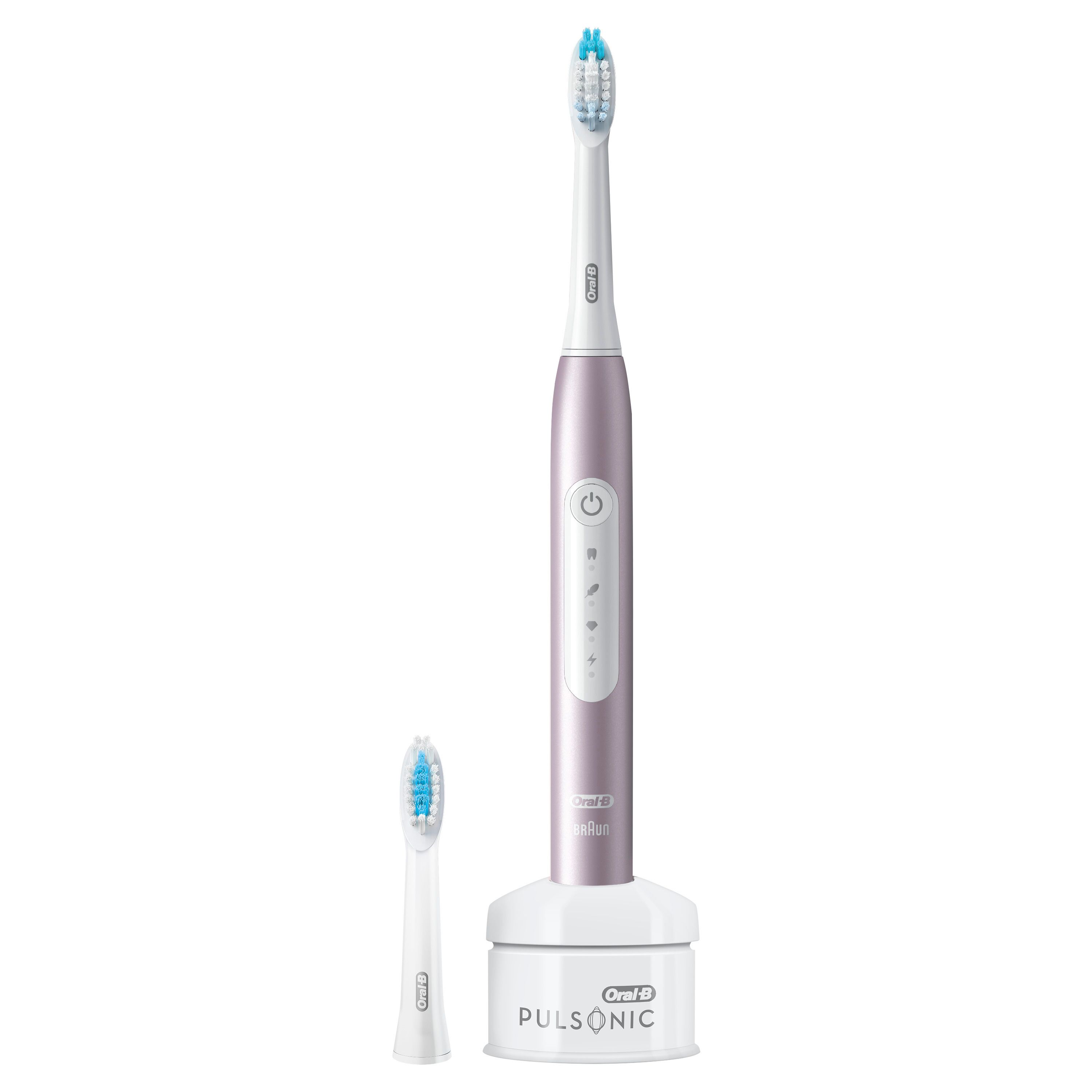 Elektrische Zahnbürste, Rosegold. Ladestation und Ersatzbürste. Oral-B Logo. Aufrecht stehend.