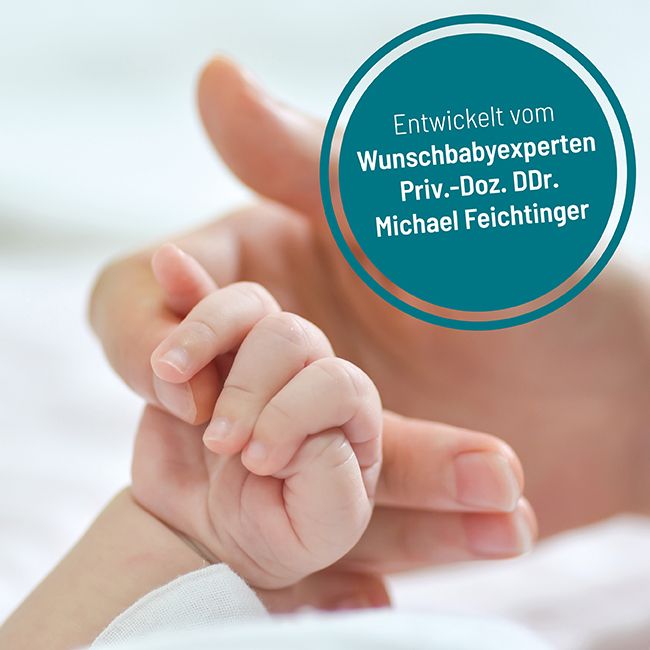 Hand eines Erwachsenen hält die Hand eines Babys. Text in einem Kreis: Entwickelt vom Wunschbabyexperten Priv.-Doz. DDr. Michael Feichtinger.