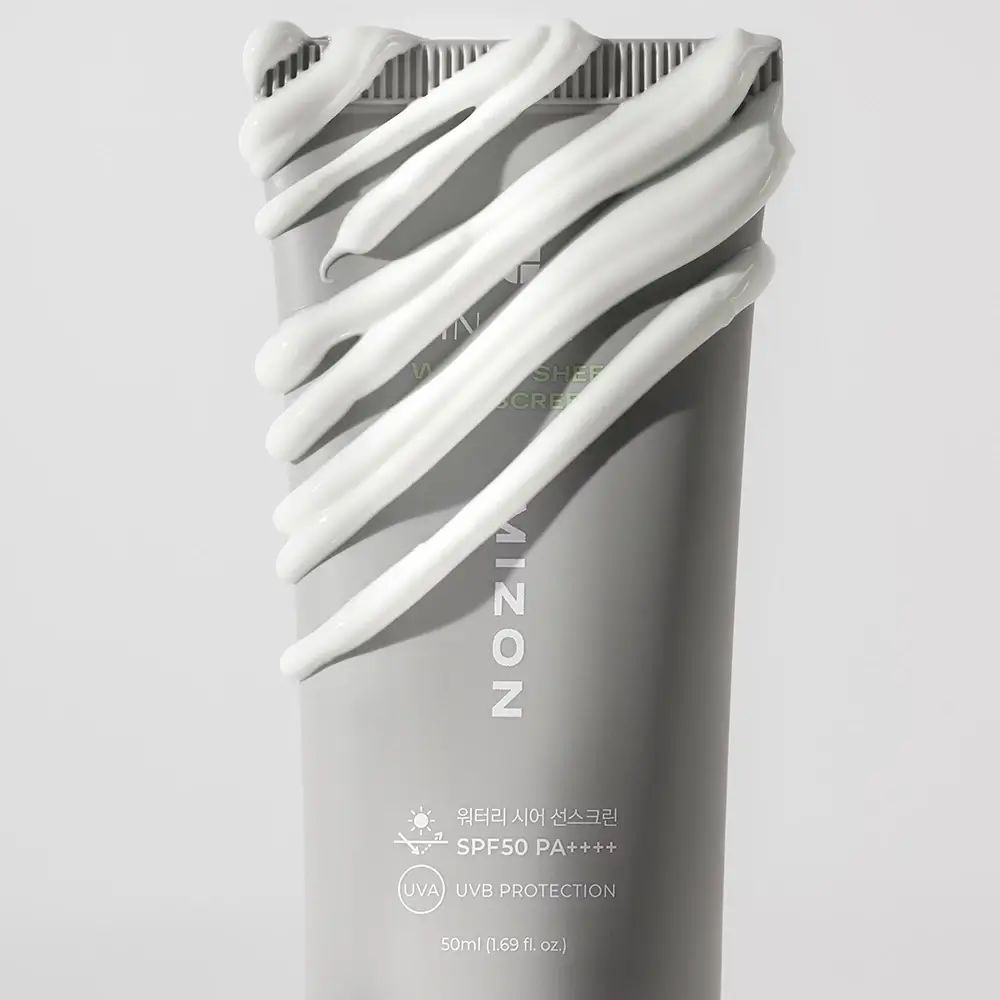 Graue Tube mit Creme. Aufschrift: MIZON, WATER SHEER SUNSCREEN, SPF50 PA++++. Creme aufgetragen.
