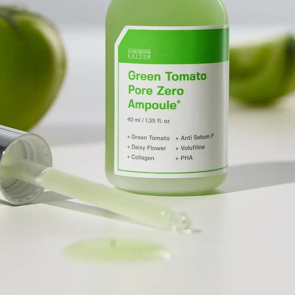 Grüne Flasche mit Pipette und grüner Flüssigkeit. Aufschrift: Green Tomato Pore Zero Ampoule+. Inhaltsstoffe sind sichtbar.