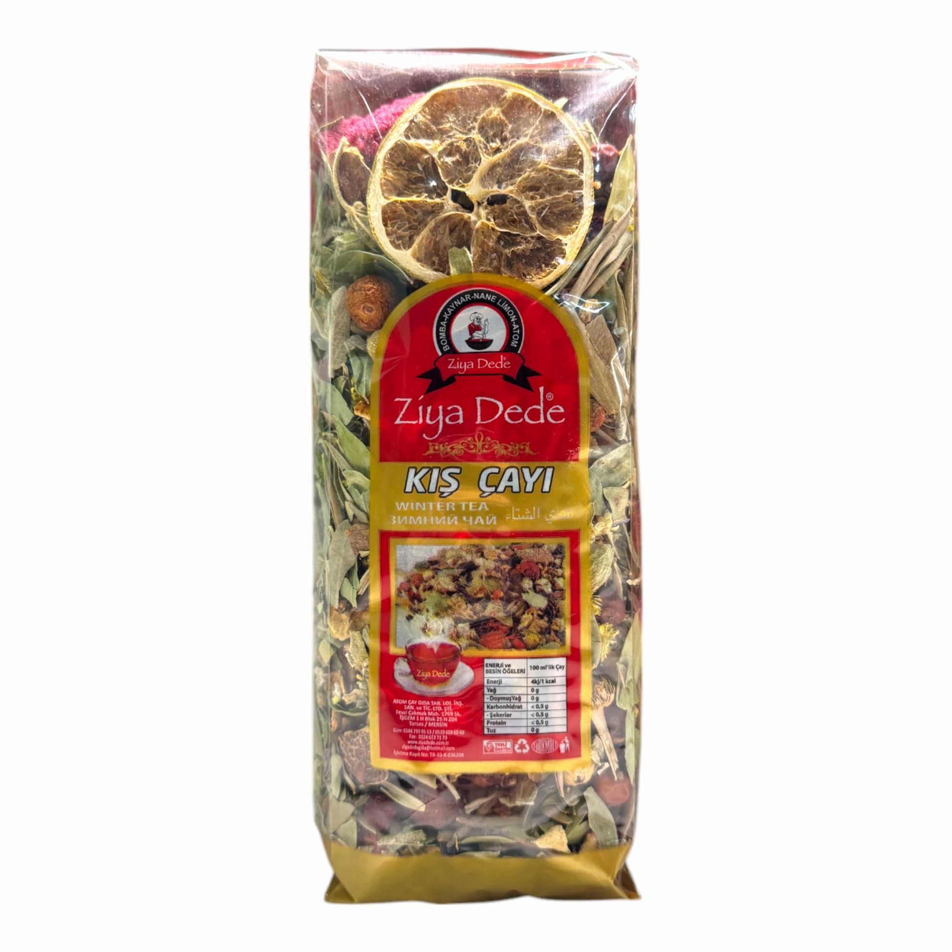 Transparente Verpackung mit Kräutermischung und getrockneter Zitrone. Rotes Etikett mit Text. Goldfarbener Boden.