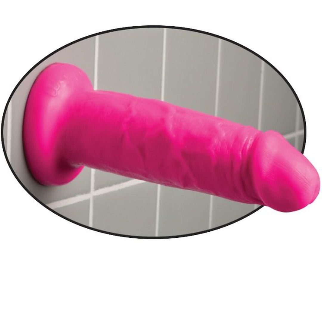 Pinkfarbener Dildo an Wand. Ovaler Rahmen. Realistische Form, texturierte Oberfläche.