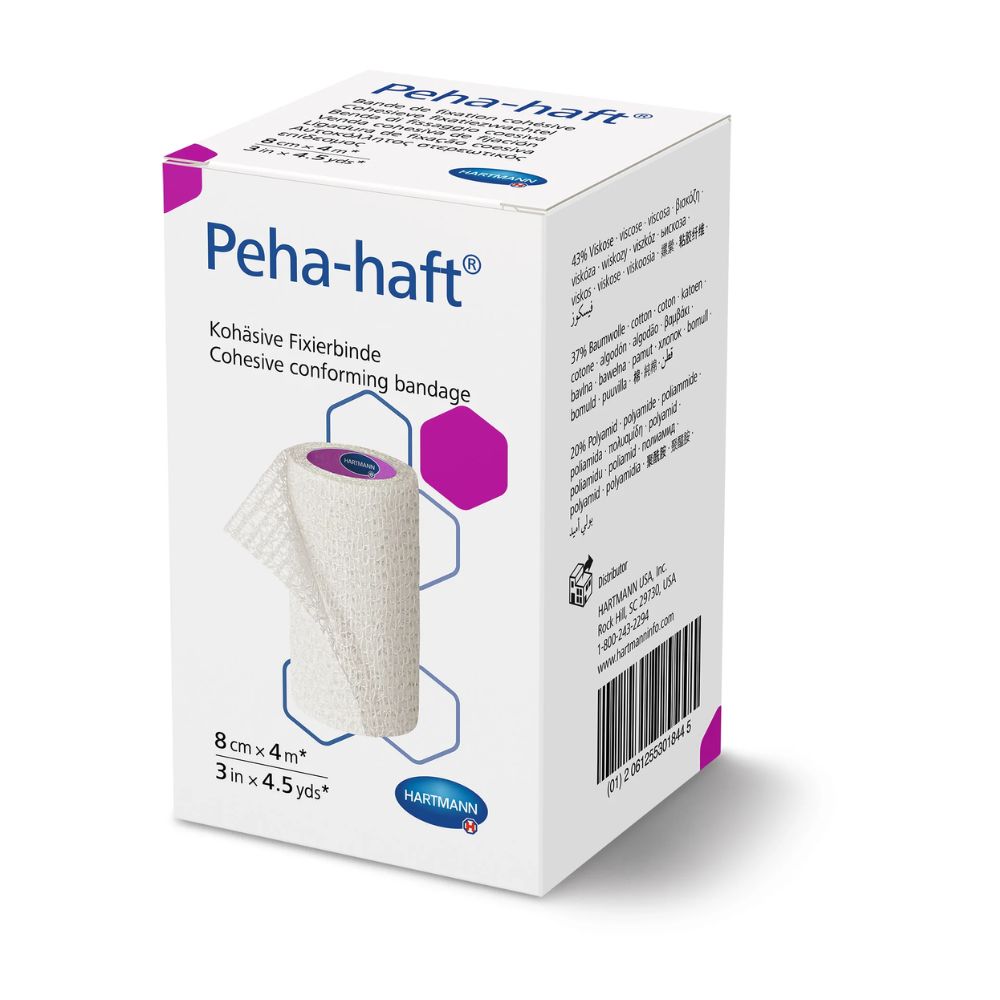 Weiße Peha-haft Fixierbinde in Verpackung. Aufdruck: Kohäsive Fixierbinde, 8cm x 4m. Marke: HARTMANN.