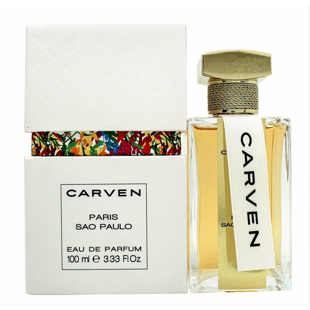 Parfümflasche und Verpackung. Flasche mit goldfarbenem Verschluss und weißem Etikett CARVEN. Verpackung weiß mit Blumenmuster.