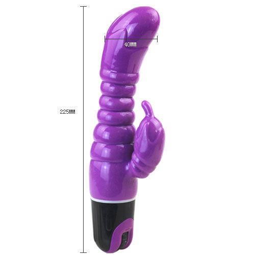 Lila Vibrator mit geriffelter Oberfläche und gebogener Spitze. Maße: 225mm lang, 40mm breit. Schwarzer Sockel mit Schalter.