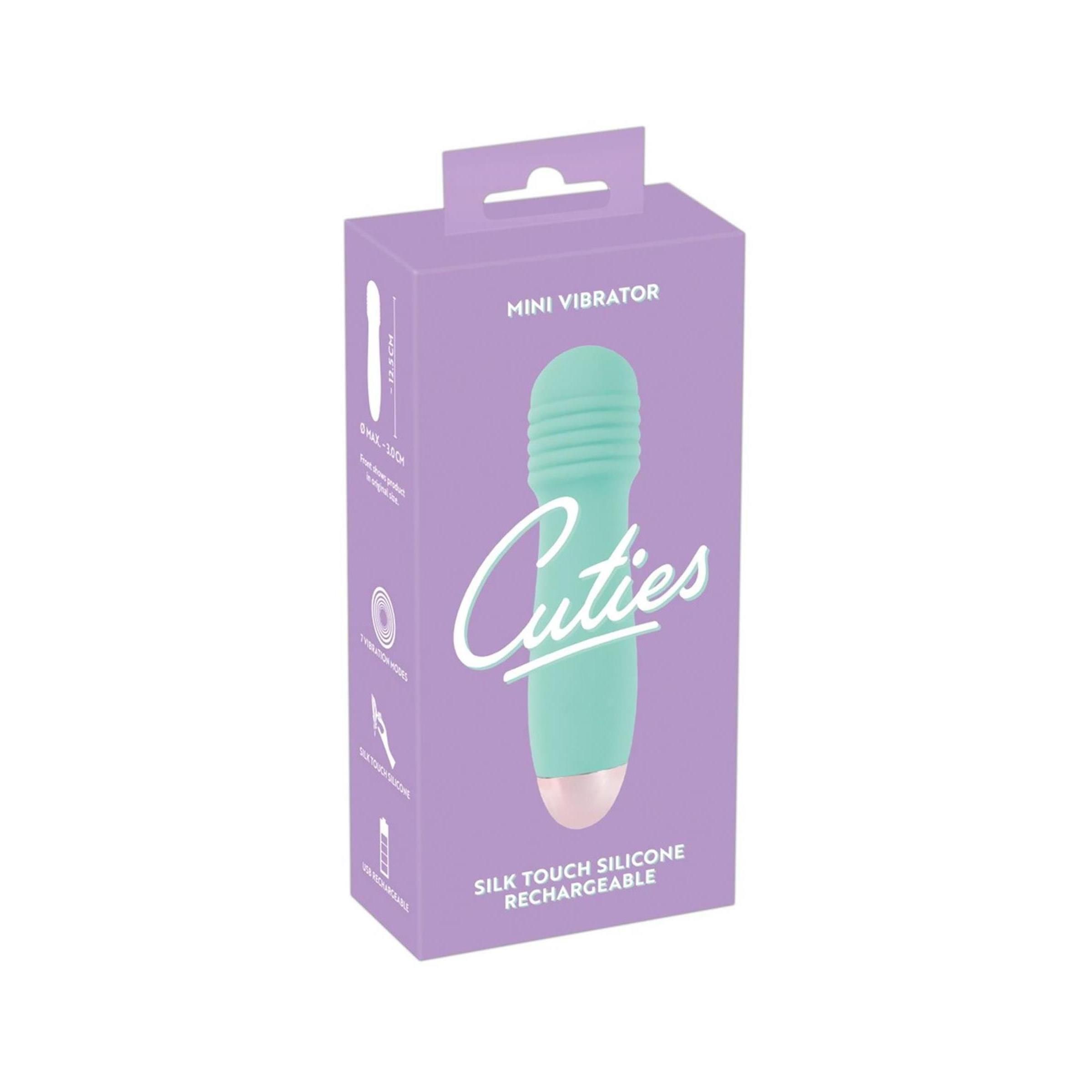 Verpackung für einen Minivibrator. Aufschrift: Cuties, Mini Vibrator, Silk Touch Silicone, Rechargeable. Produkt abgebildet.