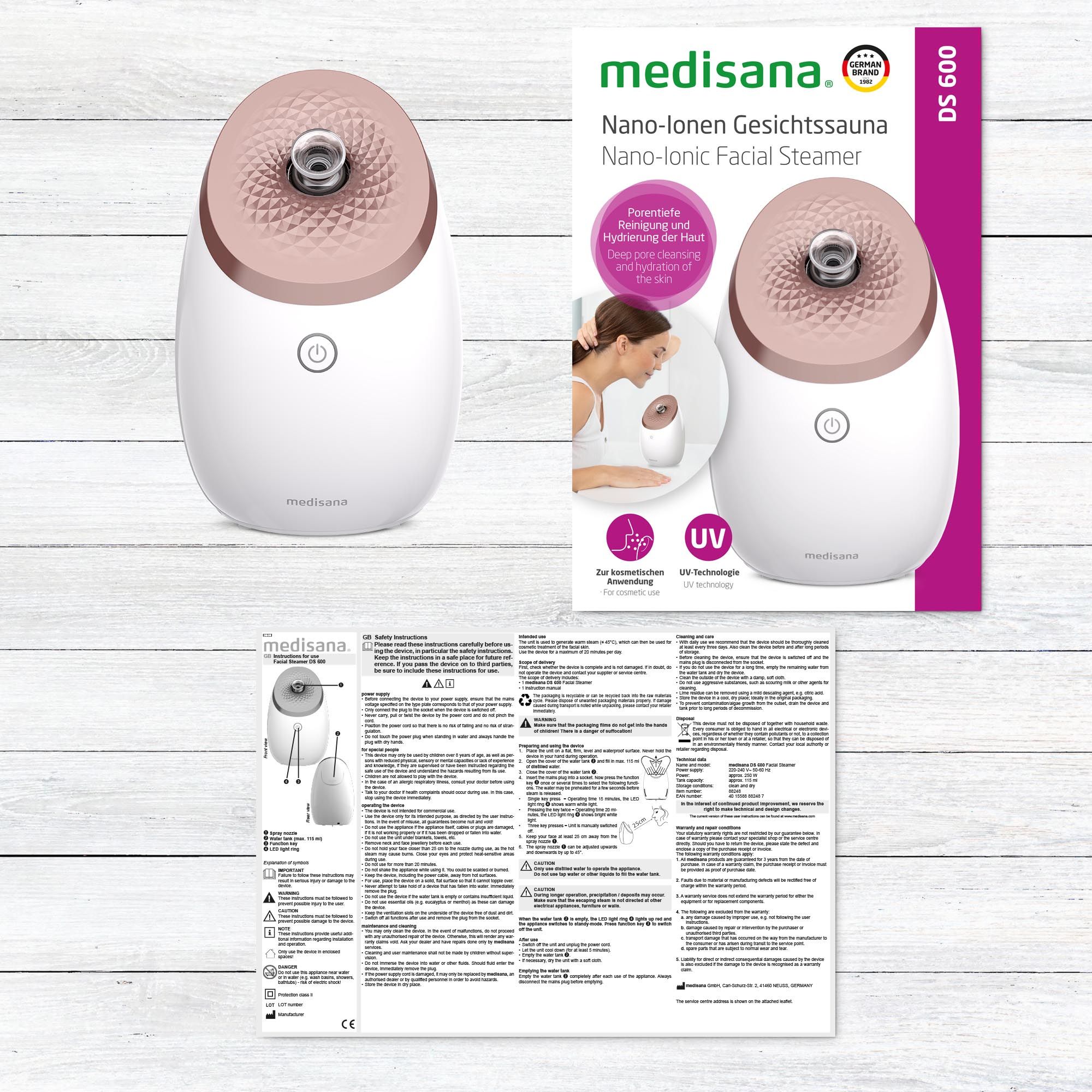 Gesichtssauna mit Verpackung und Anleitung. Gerät weiß mit roségoldfarbenem Deckel. Text auf Verpackung.