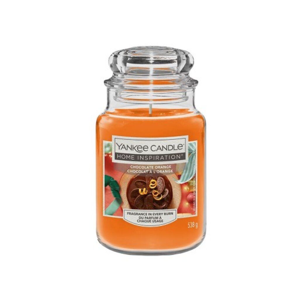 Glasbehälter mit orangefarbenem Wachs und Deckel. Etikett mit Produktnamen und Abbildung einer Schokoladen-Orange.
